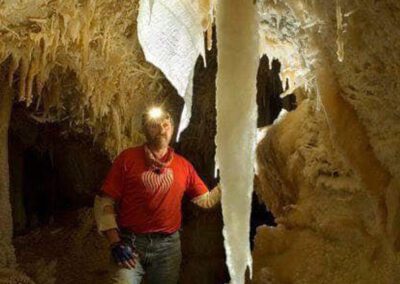 man looking at the crystals in the cave