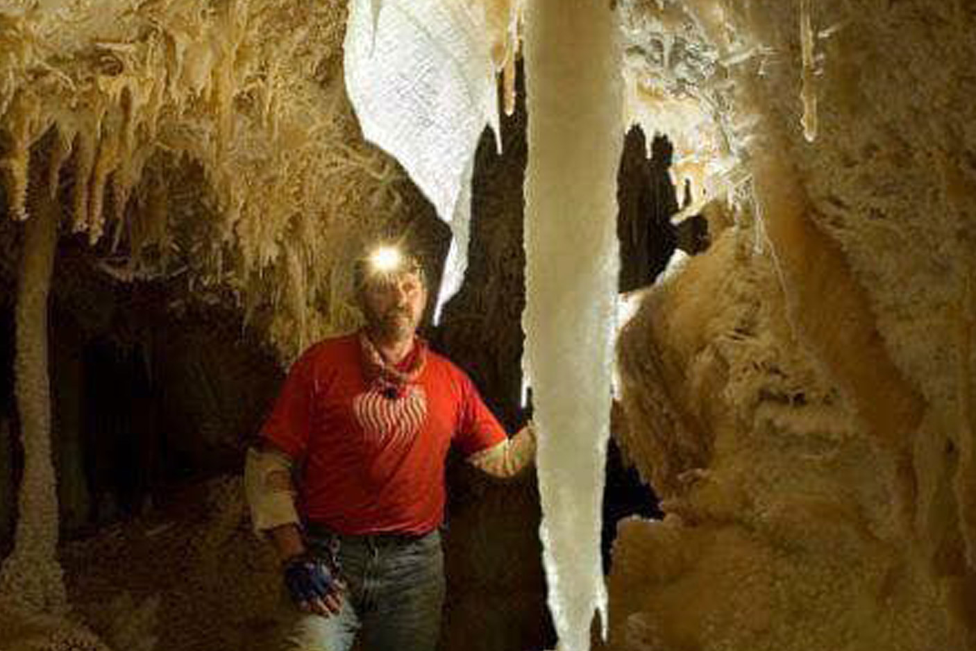 man looking at the crystals in the cave