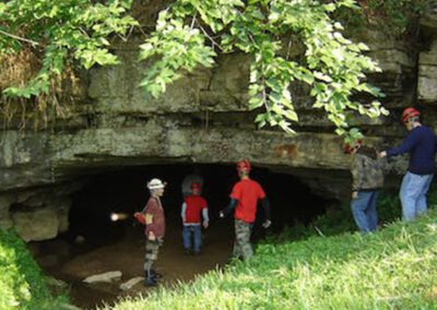people with hard hats going into cave