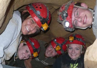 people with hard hats in the cave