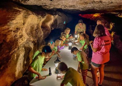 kids looking through magnifying glass inside cave